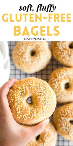 a person holding a bagel with sesame seeds on it and the text soft fluffy gluten - free bagels