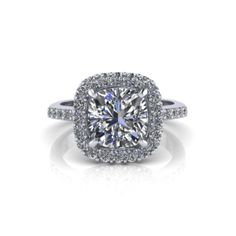 a cushion cut diamond surrounded by halos and pave set diamonds in 18k white gold