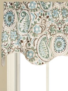 a window with a blue and brown flowered valance