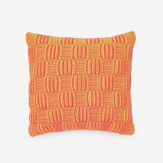 an orange and yellow pillow on a white background