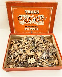 an orange box filled with lots of different types of puzzles