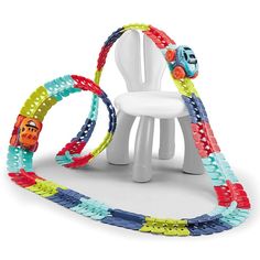 a white chair sitting next to a set of colorful bracelets