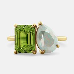 A toi et moi ring with an emerald-cut Green Peridot and a pear-cut gemstone. The emerald-cut morganite is set on the left of the ring Capricorn Ring, Aquarius Ring, Virgo Ring, Libra Ring, Aries Ring, Pisces Ring, Taurus Ring, Scorpio Ring, Gemini Ring