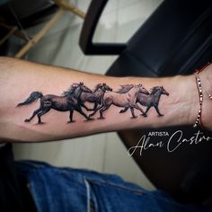 a man's arm with three horses on it