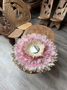 a wooden table topped with a vase filled with pink and white flowers on top of it