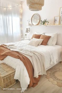 a bedroom with white walls and wooden flooring is decorated in neutral tones, such as beige