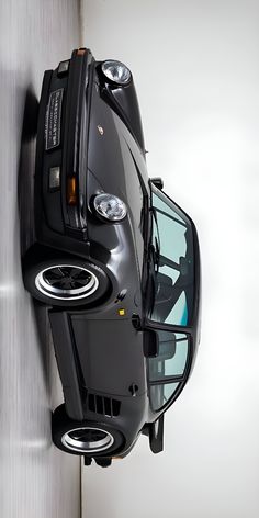 the front end of a black car is shown from above