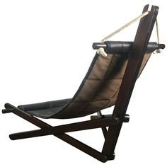 a chair that is made out of wood and leather with rope attached to the back