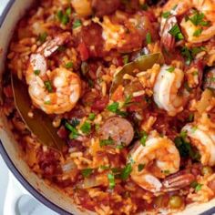 a large pot filled with rice and shrimp