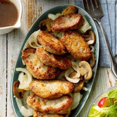 a plate full of chicken, onions and mushrooms