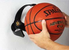 a hand holding a basketball with headphones attached to it