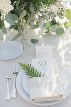 a bouquet of flowers sitting on top of a wooden table next to a white cloth