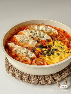 a white bowl filled with pasta and sauce