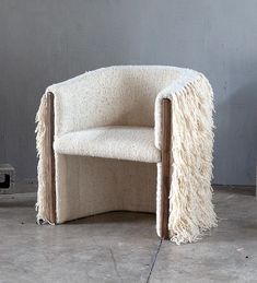 a chair that is made out of some kind of material with fringes on it