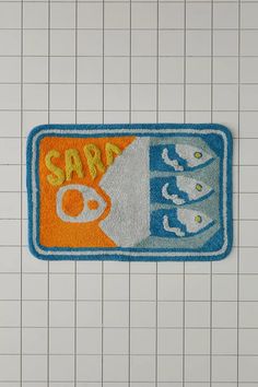 a blue and orange bath mat with the words saba on it