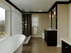 a large bathroom with a tub, sink and toilet