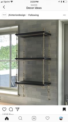 two black shelves in front of a window