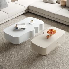 a white coffee table sitting on top of a carpeted floor next to a couch