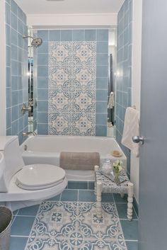 a blue and white bathroom with tile flooring