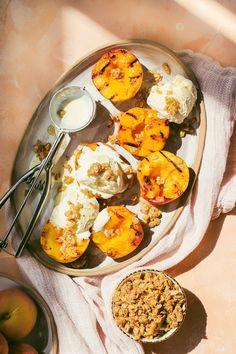 a plate with peaches, yogurt and granola on it