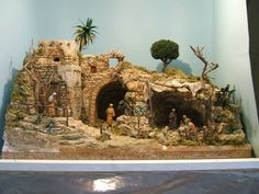 a model of a stone building with people and trees