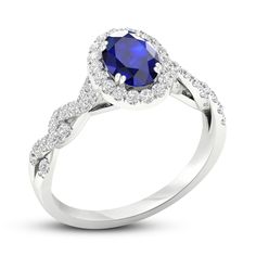 a white gold ring with a blue sapphire and diamonds