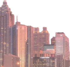 the city skyline is lit up at night with skyscrapers in the foreground and cars on the street below