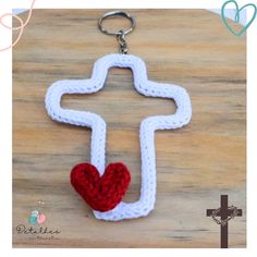 a crocheted key chain with a red heart hanging from it