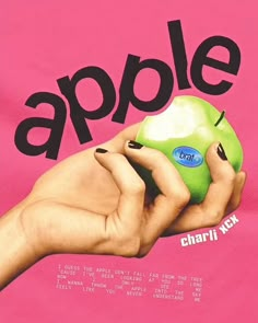 a person holding an apple in their hand with the word'apple'on it