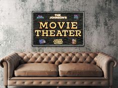 a couch sitting in front of a brick wall with the words movie theater on it