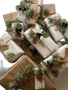 many wrapped presents are tied with twine and pine cones