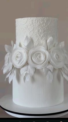 a white wedding cake with flowers on top and the words, i do not know what this is