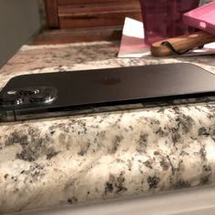 an apple laptop sitting on top of a marble counter