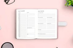 an open planner sitting on top of a pink table