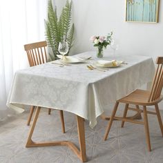 a table with two chairs and a white table cloth