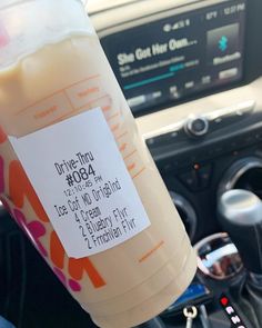 a drink sitting in the center console of a car