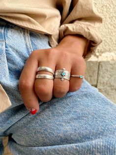 Three different stackable rings in silver color and similar philosophy. The first one is a ring that seems to have double bands. The second one is a wide ring with a turquoise rhombus charm from enamel at the center and the last one is a thin band with a turquoise heart that is made from enamel.the first two rings are slightly adjustable and the heart has fixed dimensions size 7.  You can wear them all together or separetely as well. Find them only at Christina Christi Store. MATERIALS - All Rin Rings In Silver, Rings Adjustable, Snake Jewelry, Rings Silver, Dope Jewelry, Statement Ring Silver, Funky Jewelry, Jewelry Lookbook, Trendy Earrings