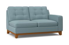 a blue couch sitting on top of a white floor