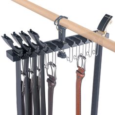 a rack with several different types of knives hanging from it's hooks and straps