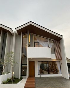 a modern house with large windows and wood accents