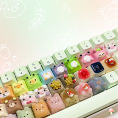 an array of small plastic animal figurines sitting on top of a keyboard