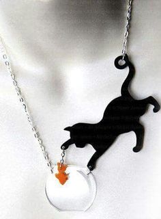 a necklace with a cat on it and a ball in the shape of a fish