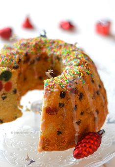 a bundt cake with sprinkles and a slice cut out on a plate