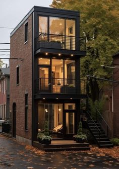 a two story house with lots of windows and balconies on the second floor