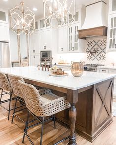 a large kitchen island with chairs around it