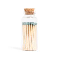 matches in a glass jar on a white background