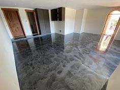 an empty room with black and white marble flooring