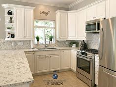 a kitchen with marble counter tops and white cabinets, stainless steel stove top oven and refrigerator