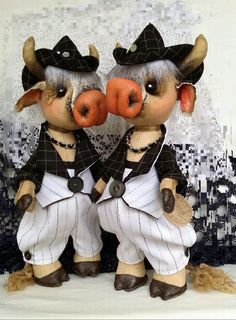 two stuffed animals dressed in baseball uniforms and hats, standing next to each other with their mouths open