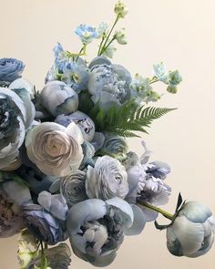 a vase filled with blue and white flowers